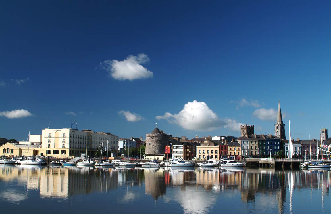 View Of Waterford Quay in Waterford City on a sunny day with buildings in the background.