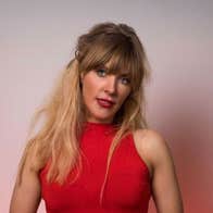 Comedian Aideen McQueen, a woman in red dress holding a mic