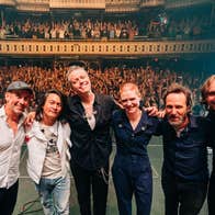 Jason Isbell & The 400 Unit, a line of people smiling on a stage with their back to a waving audience