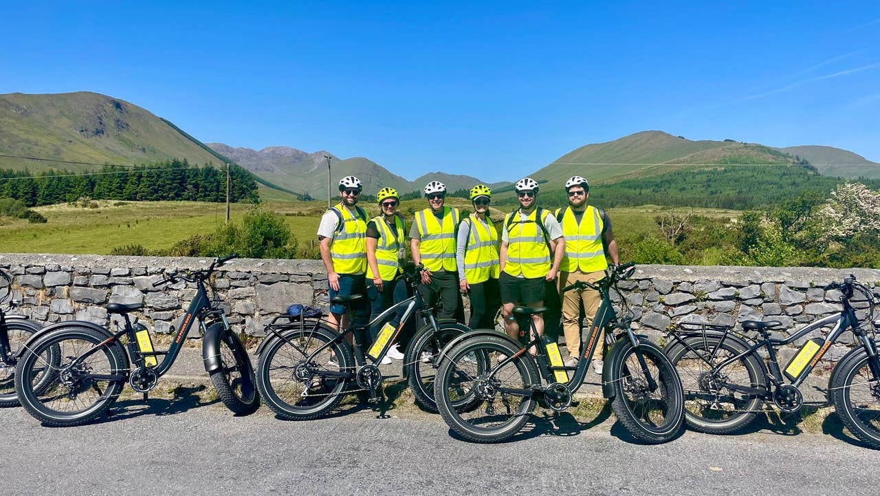 Cyclists with fat bikes under a blue sky