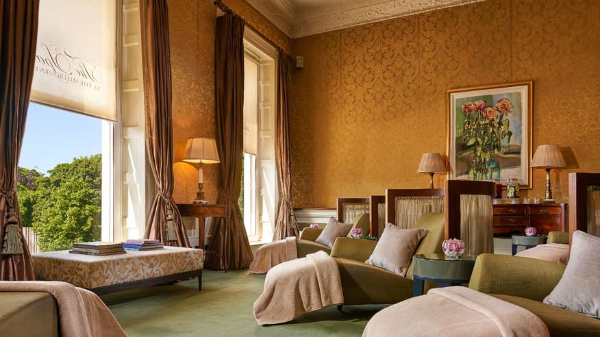 Interior facade of the spa at The Shelbourne Hotel with luxurious chez lounges and bulky drapes.