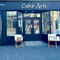 Art gallery exterior with small easels on display at the door