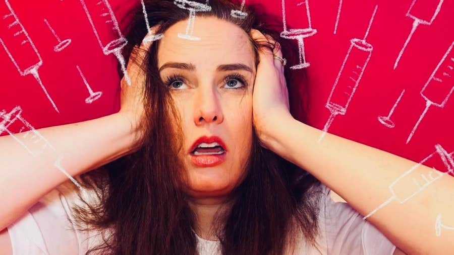 A woman looking upwards in despair with her hands either side of her head.