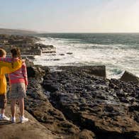 Two young girls looking out at the ocean in The Burren, Co Clare
