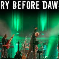 A band performing in stage with green lighting