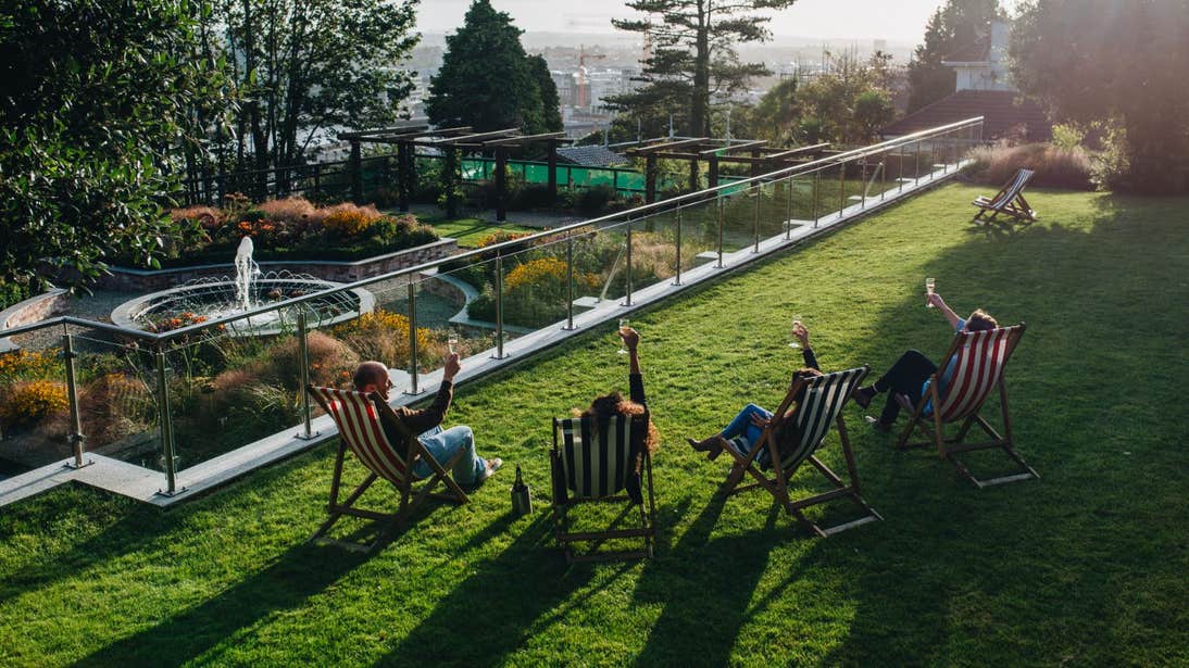 People sitting in the sun in beach chairs in Cork City