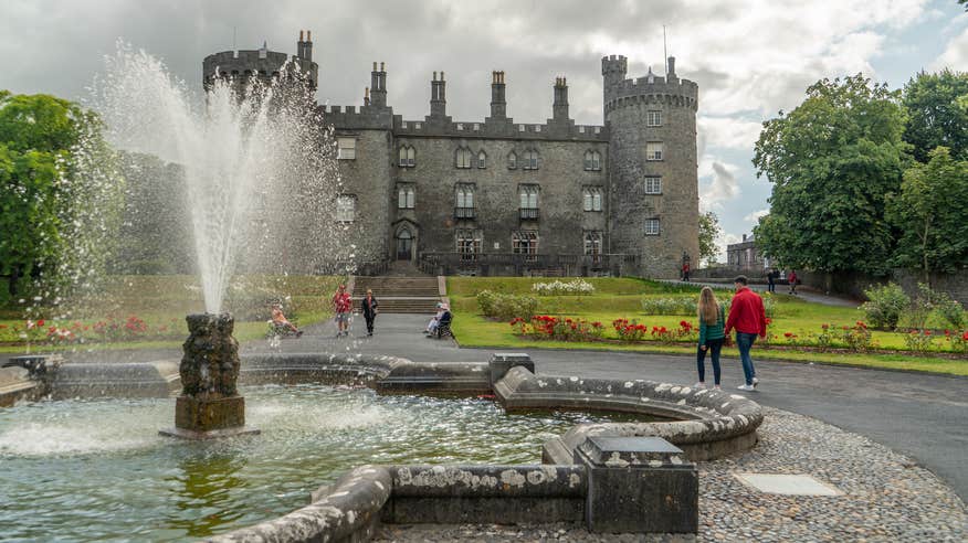 People strolling the grounds of Kilkenny Castle in County Kilkenny.