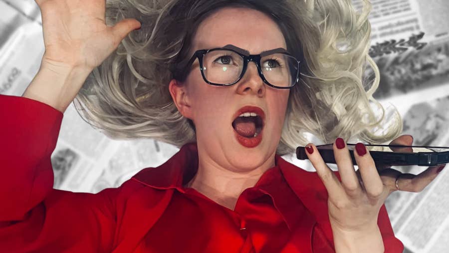 A woman in bright red shirt is shouting into a phone she is holding