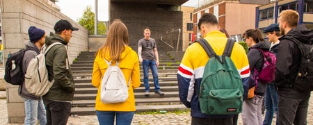 A guide speaking with a tour group in Smithfield Square