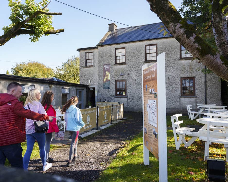 A family walking down the laneway to enter The Maria Edgeworth Visitor Centre