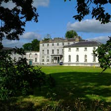A blue sky and green parklands at Strokestown Park House and Garden