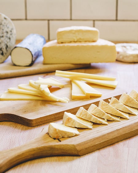 Selection of cheeses on serving board