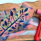 Monoprinting with Susan Leen - Looking down at a printed, layered image of a branch with different colours and a small roller.