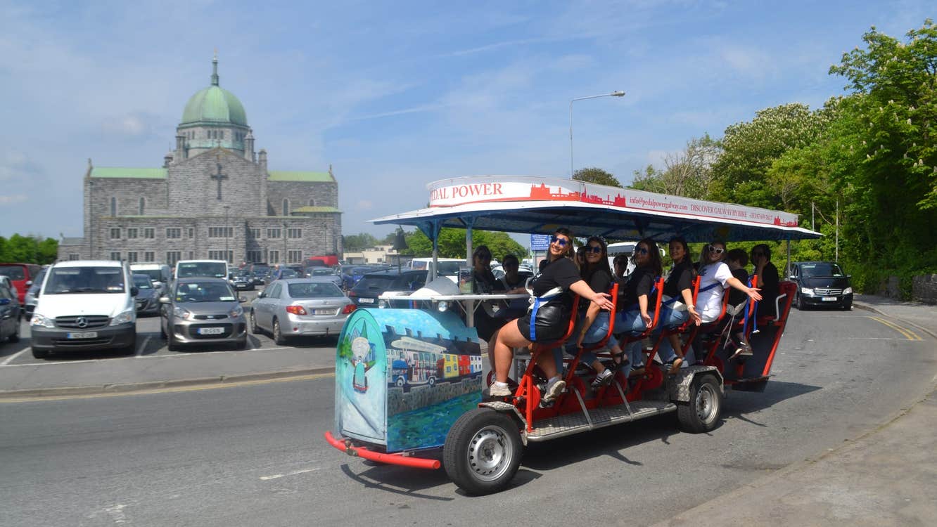A group of ladies enjoy a tour on a pedal powered bike
