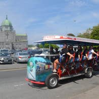 A group of ladies enjoy a tour on a pedal powered bike