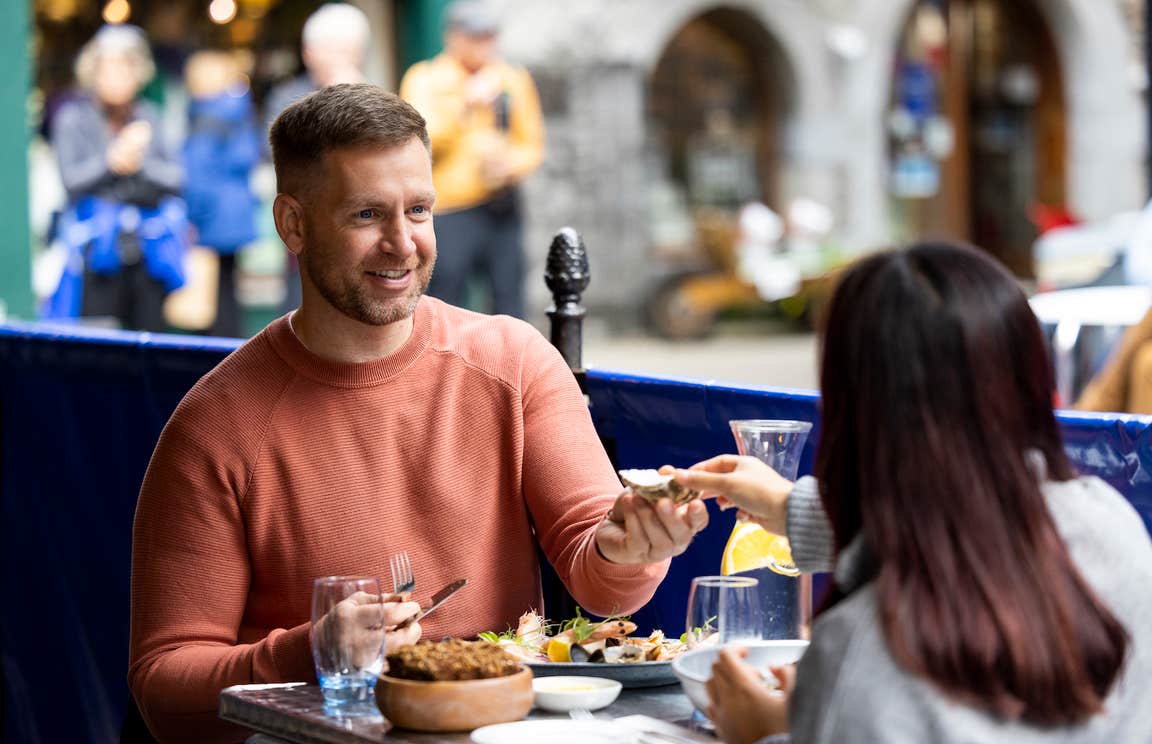 A couple eating food in Galway city