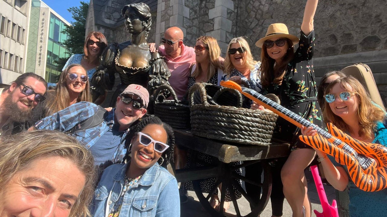 A group of people at the Molly Malone statute in Dublin on a Songwriters Tour