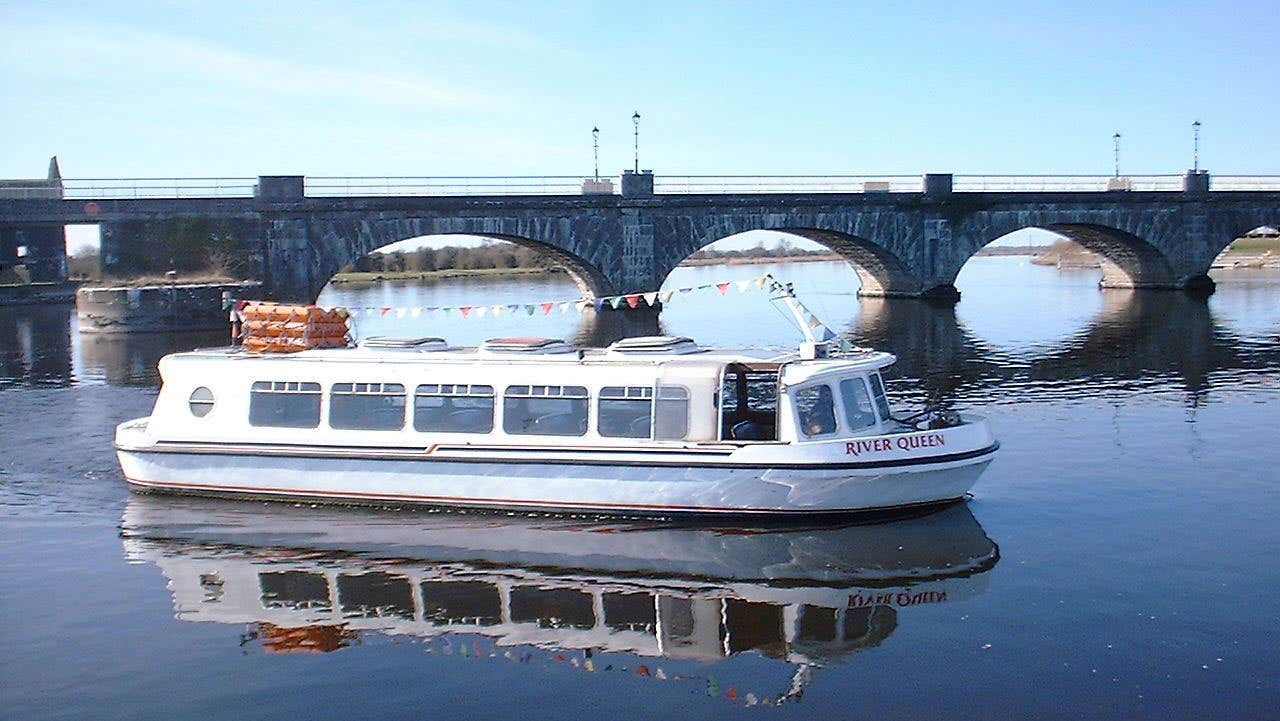 Silver Line Cruisers river queen boat on the water near a bridge