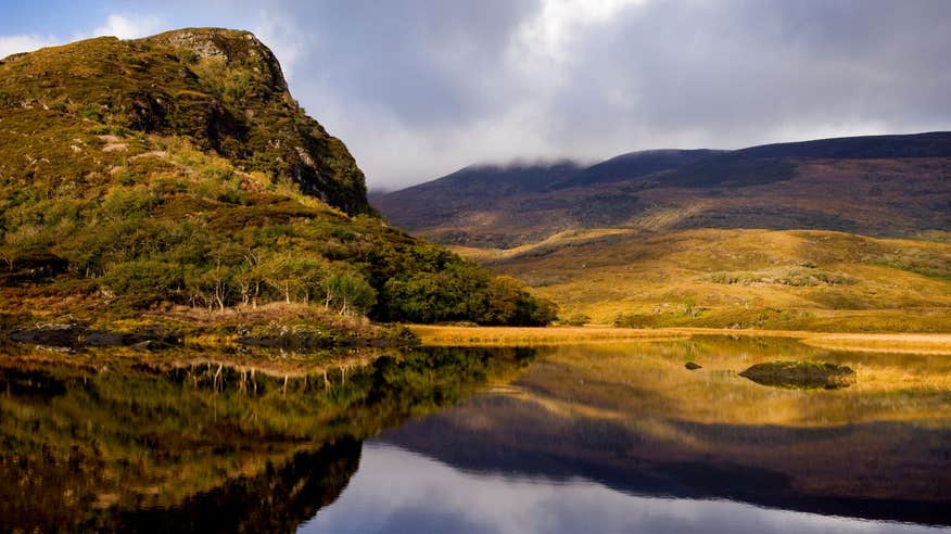 Rolling mountains beside lakes at Killarney National Park, Ring of Kerry, County Kerry on a cloudy day.