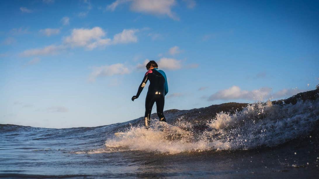 A surfer riding a wave at Brittas Bay in Wicklow.