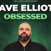 Comedian Dave Elliott, a slightly frowning man with beard and bald head.