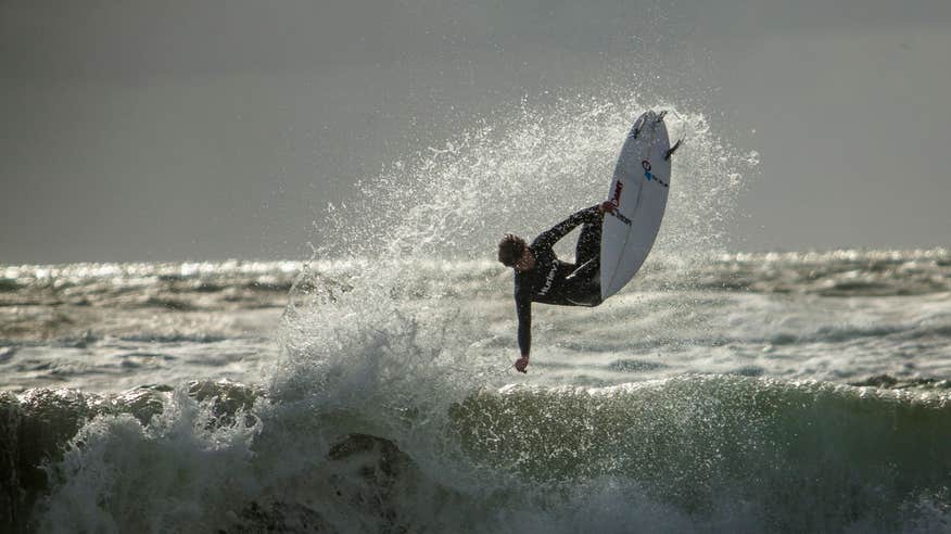 Surfer doing tricks in the waves in Sligo.