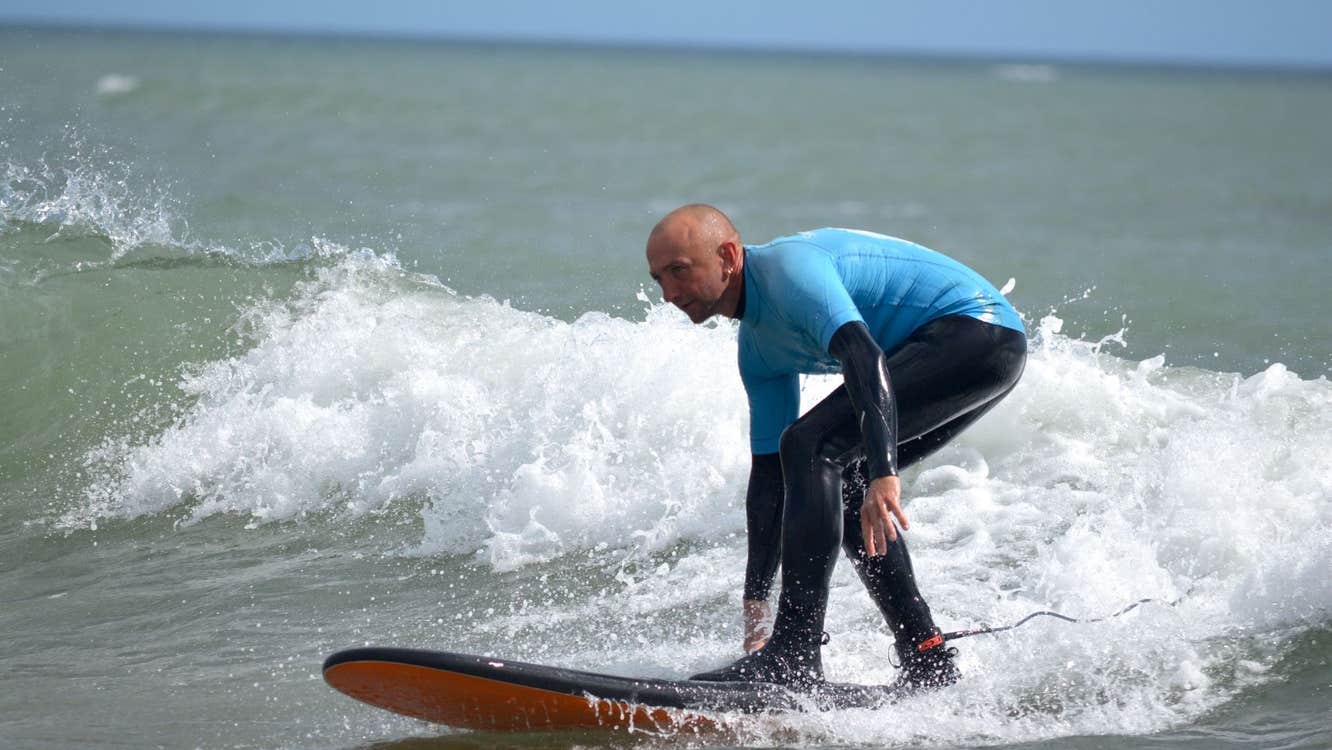 A close up of a man on a surf board