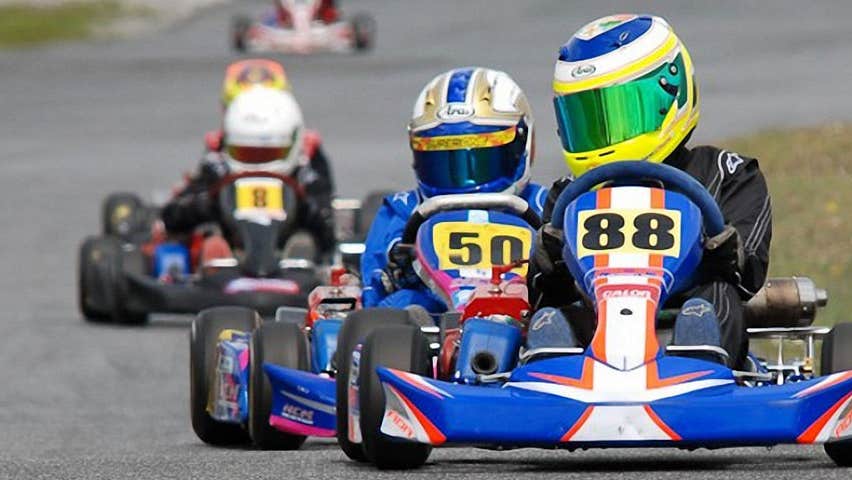 a group of karters rounding a bend at Pallas Karting