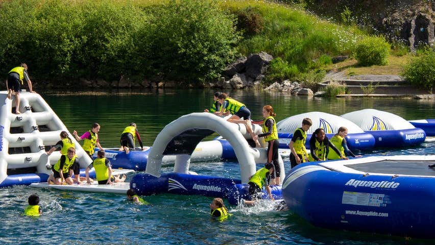 A floating obstacle course on a lake with people on it