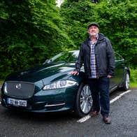 A man posing with a car