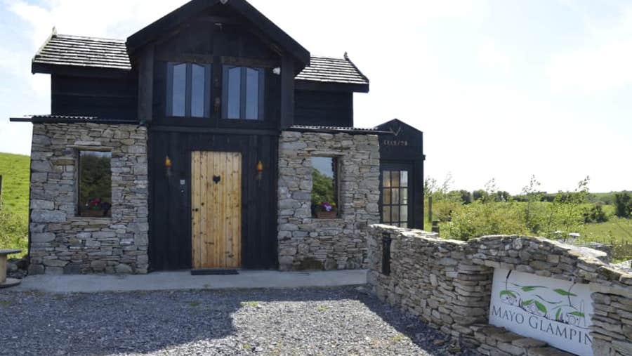 Front view of property with wooden door