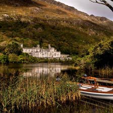 A white wooden boat on the lake near Kylemore Abbey in County Galway