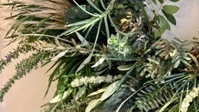 Part view of green foliage as part of a wreath.