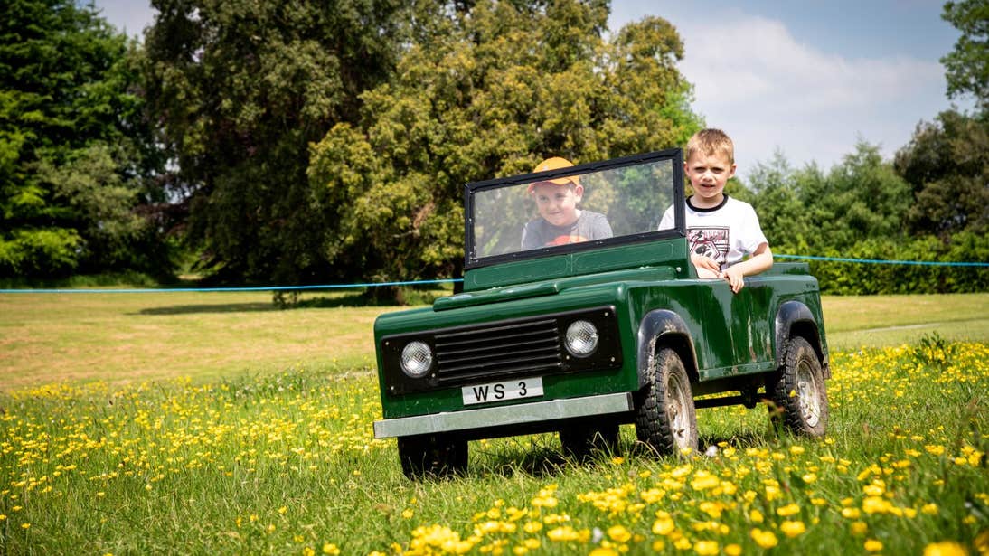 Children driving a toy car in Lough Key Forest and Activity Park, Roscommon