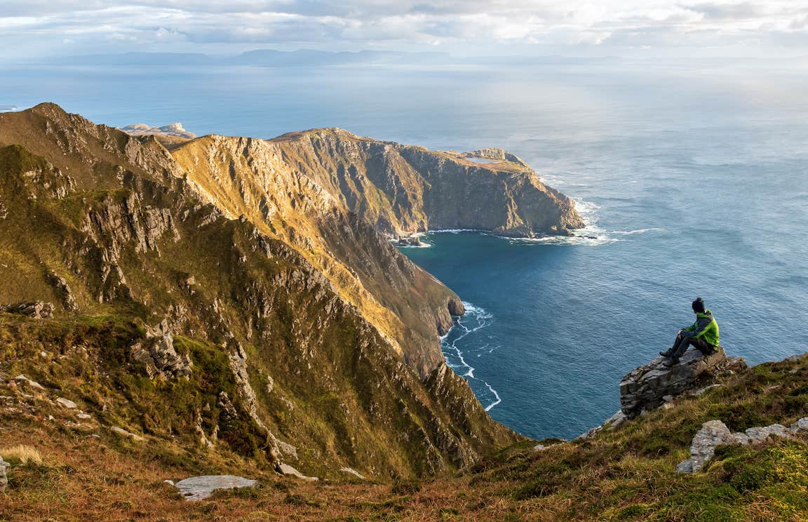 A hiker at Sliabh Liag (Slieve League) cliffs in Co Donegal