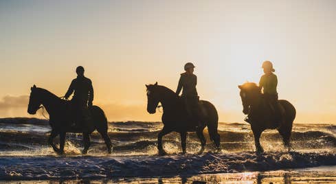 Three horse riders at Brittas Bay in County Wicklow