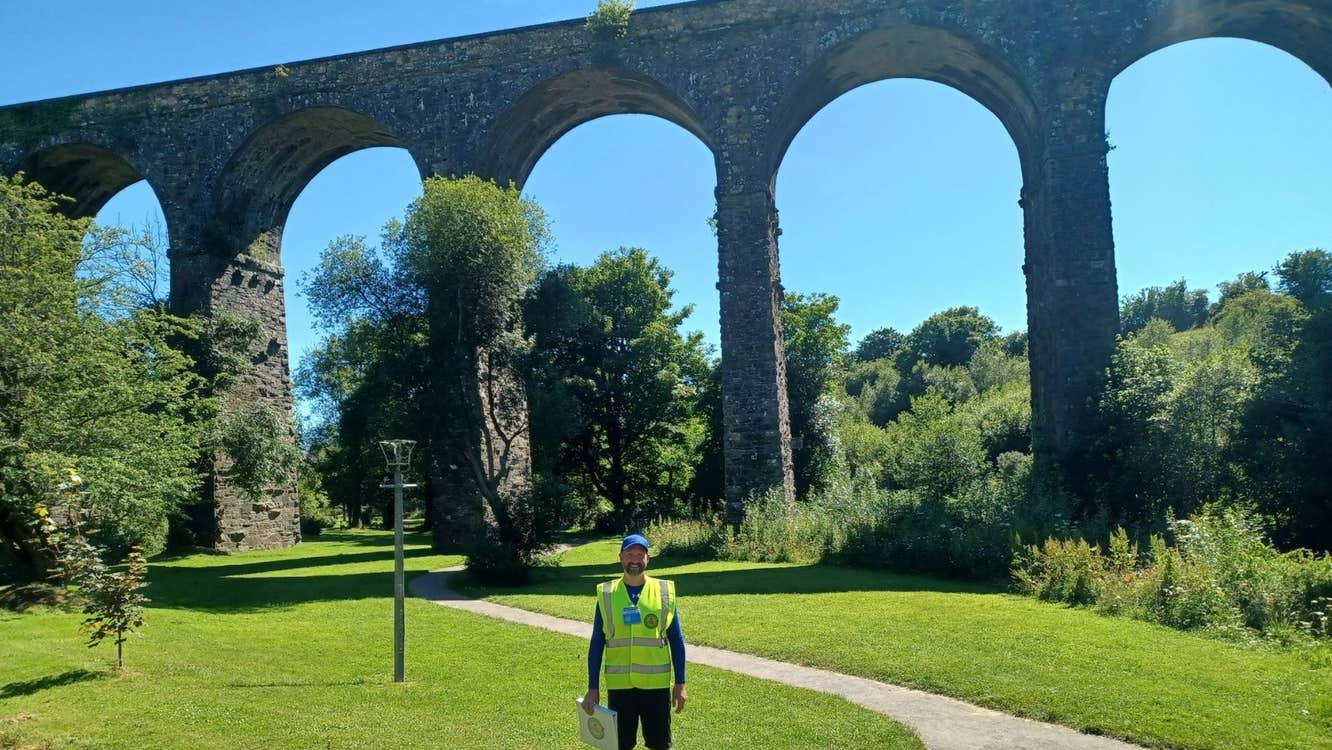 A view of a walking guide standing beside the Kilmacthomas Viaduct