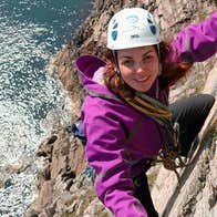 Girl climbing rockface at Donegal Climbing Muff Malin Head County Donegal
