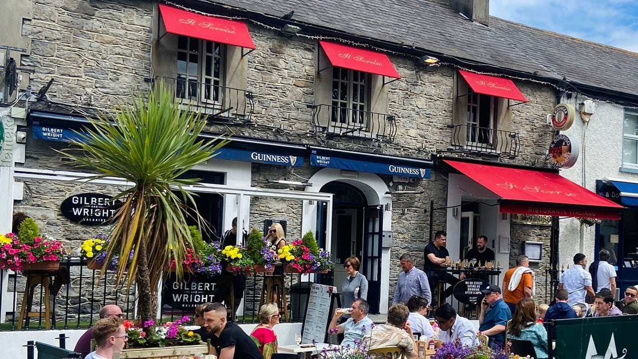 People sitting in a dining area outside a pub