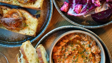 A selection of small plates with toasted bread and toppings