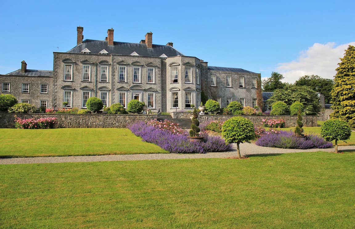 Immaculate lawns and flowerbeds outside Castle Durrow back garden in County Laois