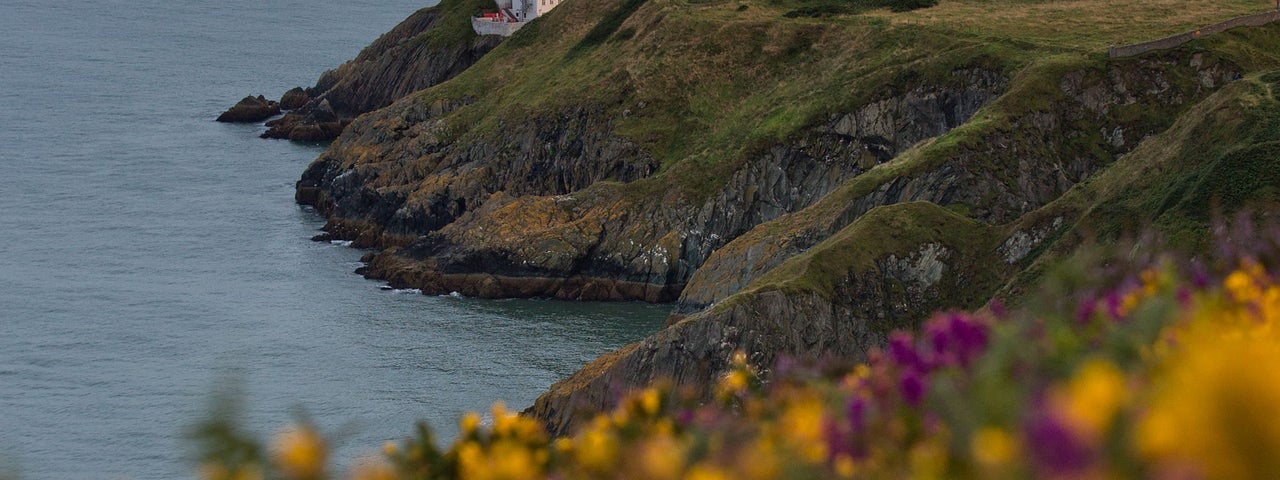 Image of a small house and the lighthouse at Howth Head, Dublin