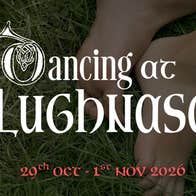 Feet in the grass with the title of the play in white writing