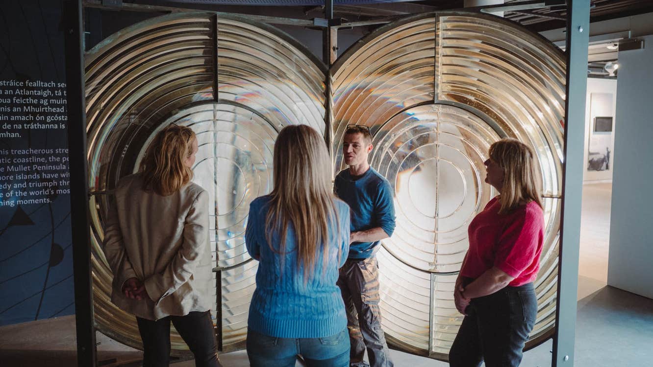 People standing and listening while on a guided tour around the Solas Visitor Centre