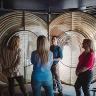 People standing and listening while on a guided tour around the Solas Visitor Centre
