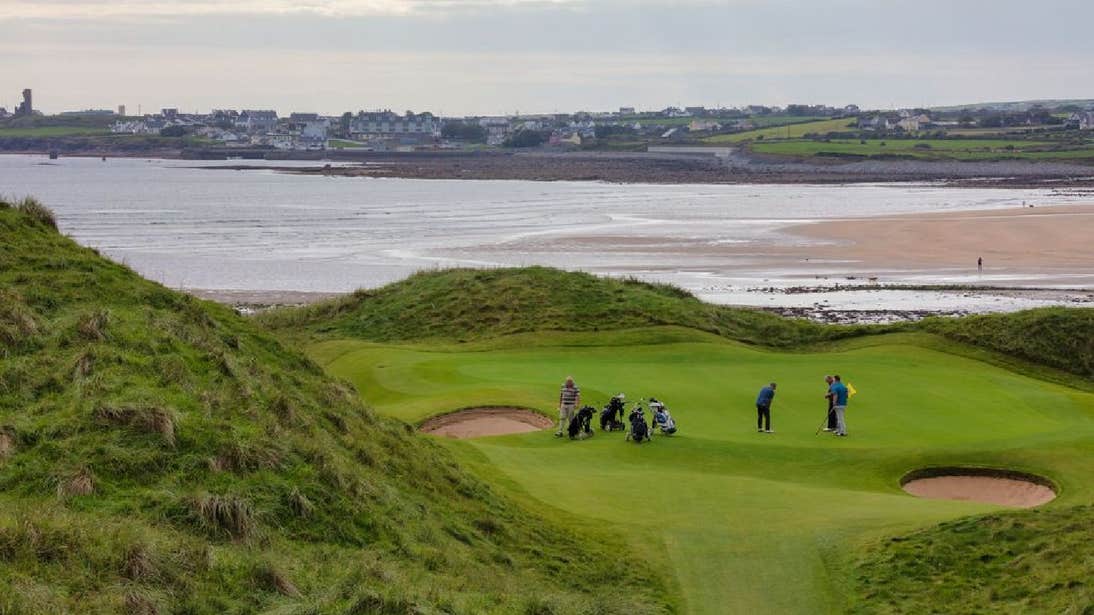 Group of golfers playing golf with coastal views Lahinch Golf Club County Clare