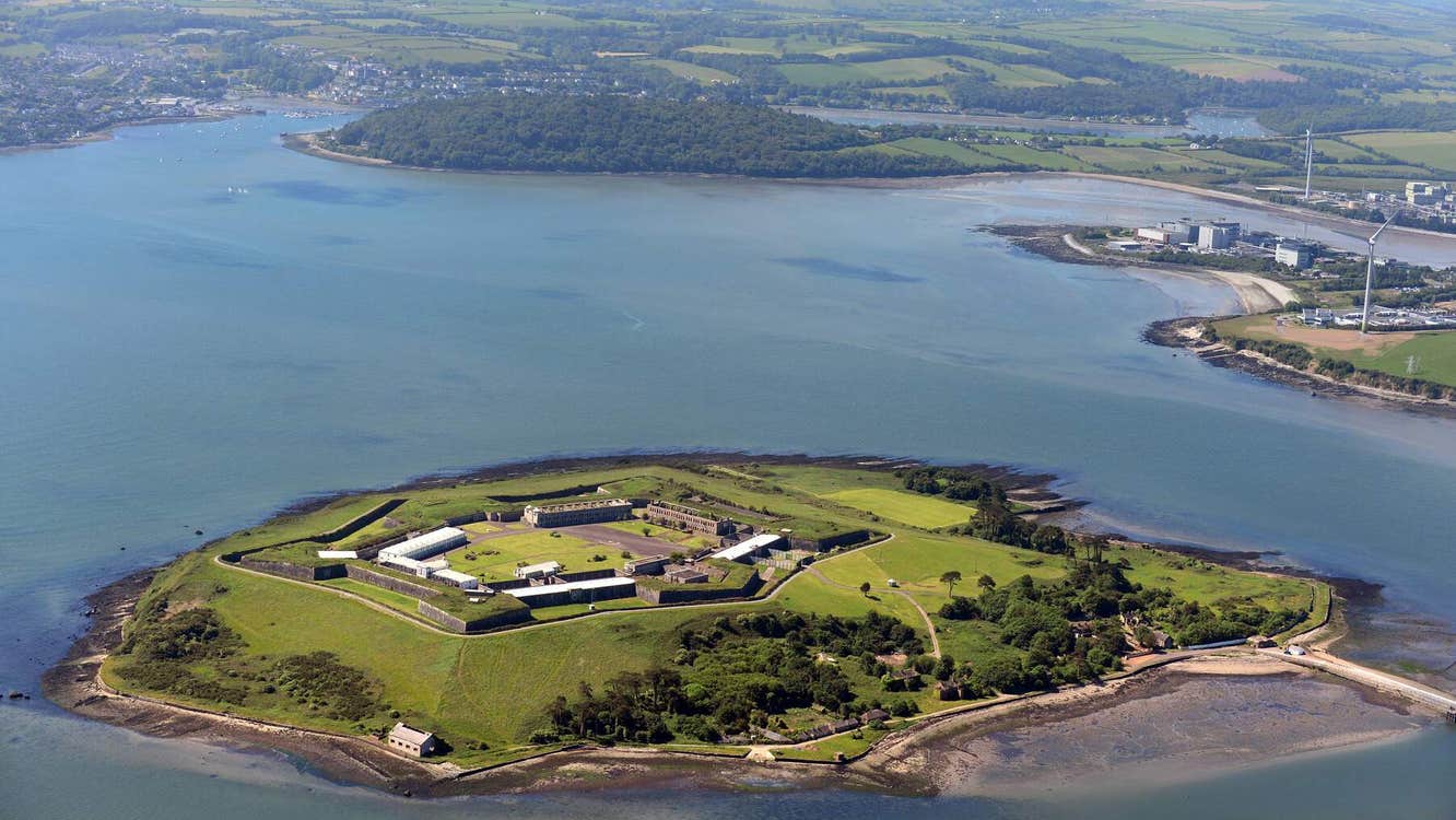 Island from the air with the sea around it and mainland in the background