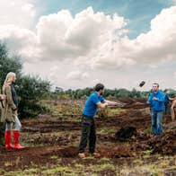 A group of people watching staff demonstrate activities at Lullymore Heritage Park, Co. Kildare
