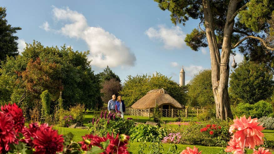 A couple walking through the National Botanic Gardens with views of vibrant flowers and plants