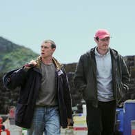 Two men walking along a dock.